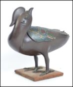 A Chinese bronze and enamel decorated incense burner in the form of a duck having pierced swivel top