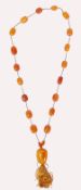 A mid 20th century butterscotch amber necklace. Th