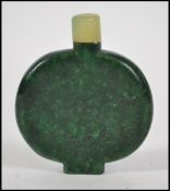 A Chinese jade scent bottle of simple form surmoun