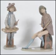 A large Nao figurine of a girl painting complete w