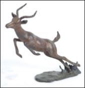 A vintage 20th century bronze figure of a leaping
