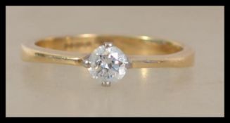 A hallmarked 18ct gold ring set with a single bril