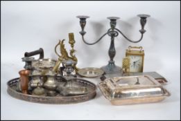 A good collection of metal ware to include silver plated part tea service, large candelabra,
