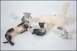 A collection of cat figurines to include Royal Doulton white Persian cat together with a Beswick