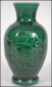 A Chinese milk glass vase having a green glaze fin