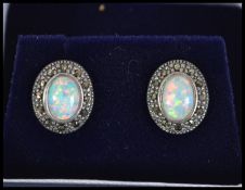 A pair of silver marcasite and opal stud earrings