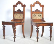 A Pair of Victorian oak hall chairs raised on turn