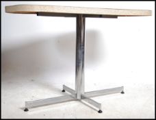 A 1950's American style chrome and formica dining table having chrome pedestal support, the