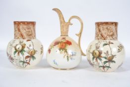 A pair of  Royal Doulton Pomegranate pattern vases decorated in the Aesthetic style with birds,