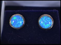 A pair of silver and blue opal ladies stud earring