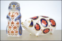 A Crown Derby gold stopper Pig and gold stopper Ch