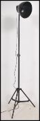A retro style ebonised metal tubular adjustable tripod floor lamp, fitted with an adjustable conical