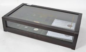 A collection of USA American coins and coinage held within a glass display case.