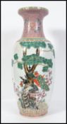 A large 20th century floor standing vase decorated heavily with birds of paradise. Measures 62cm