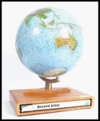 A vintage 20th century retro desk top globe raised