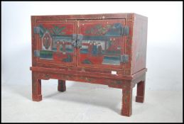 A 20th century Chinese lacquered cabinet on stand.