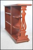 A Regency style mahogany open window bookcase cabi