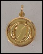 An 18ct gold pendant with fish motif. Marked 750 t