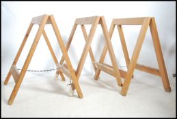 A set of 3 industrial wooden trestle table bases,