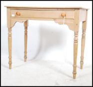 A Victorian country pine writing table being raise