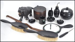 A collection of vintage 20th century ebony wares to include a dressing table set, jars / storage