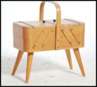 A mid century small proportioned sewing box with e