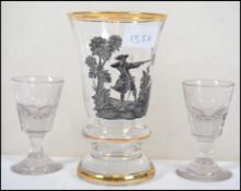 A pair of 19th century port glasses together with a glass chalice of large form with a painted