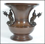 A 19th century large Chinese bronze temple vase. Of baluster form with twin handled fu-dog sides