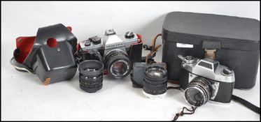 A vintage Praktica MTL3 SLR camera together with a