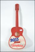 A retro 20th century plastic guitar boss in red, white and blue having notation for Boss Guitar