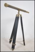A 20th century brass two draw telescope raised on