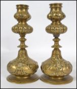 An unusual pair of believed 19th century candlesticks of tapering bulbous form depicting the Green