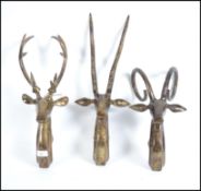 A group of three contemporary brass wall hanging f