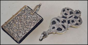 A silver white metal Aide Memoir with four fitted