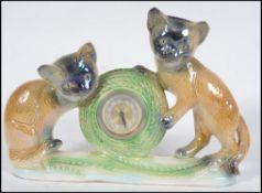 A mid century kitsch clock ceramic figurine in the