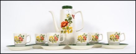 A retro 1960's  Chartwell coffee service decorated with roses stamped to base consisting of cups,