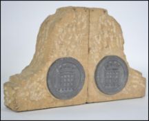 A pair of bombed out britain bookends in stone wit