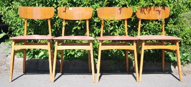 A set of 4 mid century utility beech wood dining k
