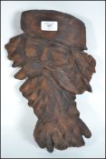 A believed 19th century Continental carved oak black forest wall mask in the form of a