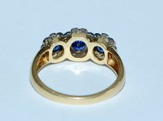 A hallmarked 18ct gold blue sapphire and diamond r