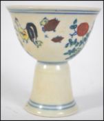 A Chinese ceramic 20th century double egg cup decorated with scenes of birds, chickens and