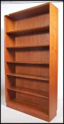 A retro 20th century tall teak open bookcase havin