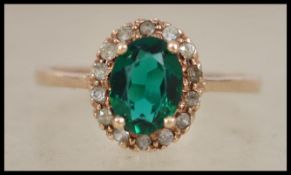 A 9ct gold ladies ring inset with green and clear
