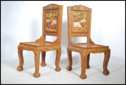 A pair of 20th century carved hardwood hall chairs