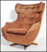 A retro Parker Knoll style large batwing swivel eg
