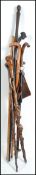 A collection of African and Polynesian hard wood carved walking sticks and staffs along with an