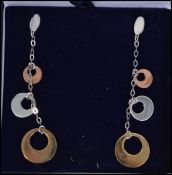 A pair of white gold and yellow gold graduating ci