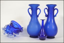 A collection of blue glass to include a pair of vases, a studio glass bowl and a blue glass bottle