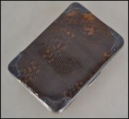 A silver and snakeskin gentlemans wallet. The wall