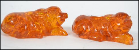 A pair of 20th century amber style figures of recu